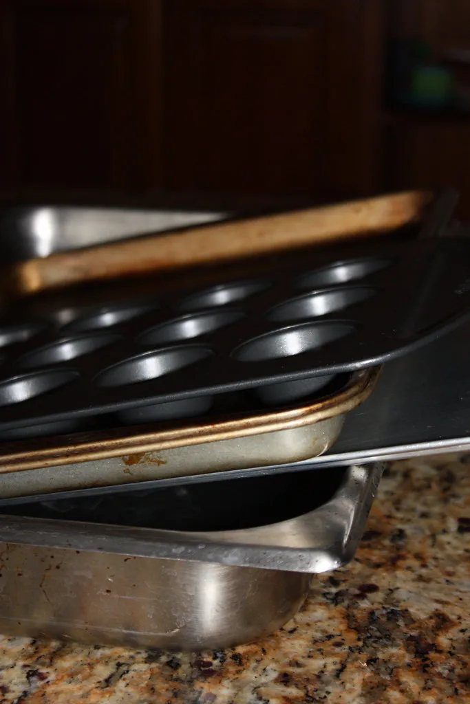A baking sheet with roasted vegetables and unevenly browned cookies in a home kitchen