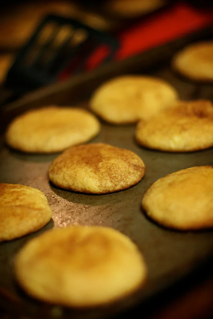 Heart-shaped cookie dough cutouts on a parchment-lined baking sheet