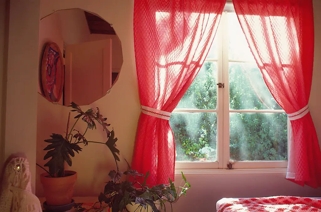 Paint swatches and fabric samples on a bedside table in natural light