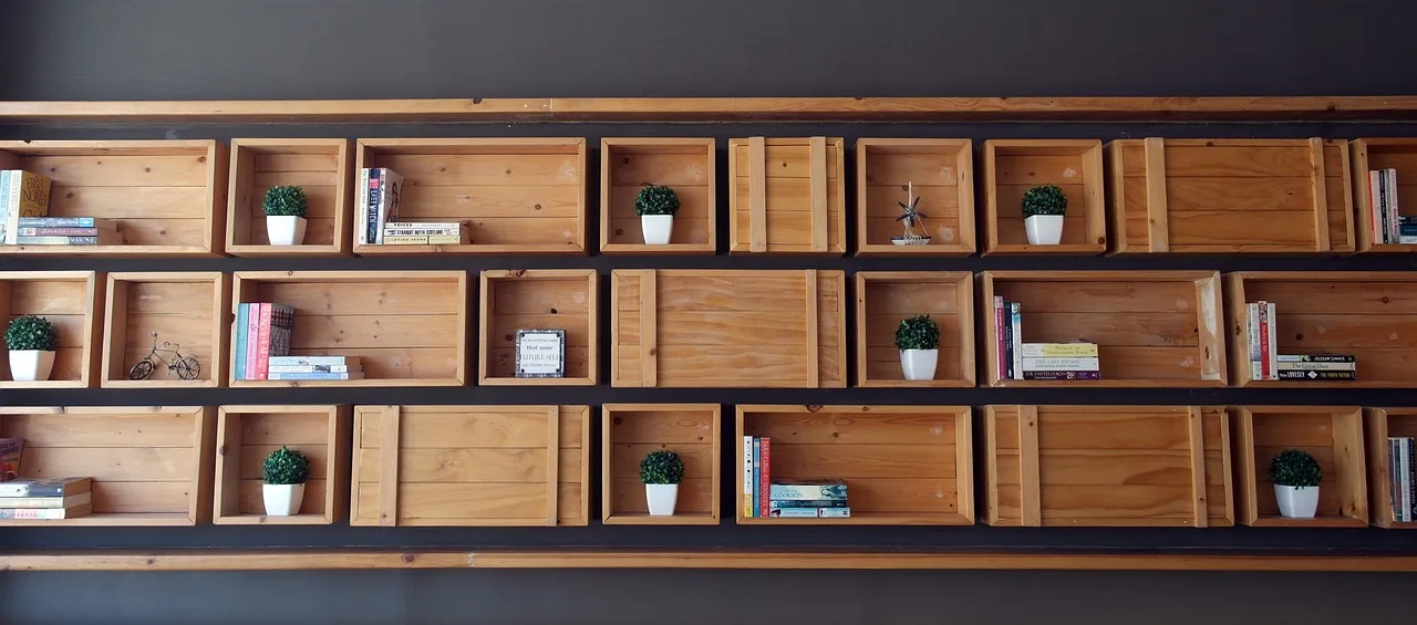 Home office with a practical bookshelf beside a desk in natural light
