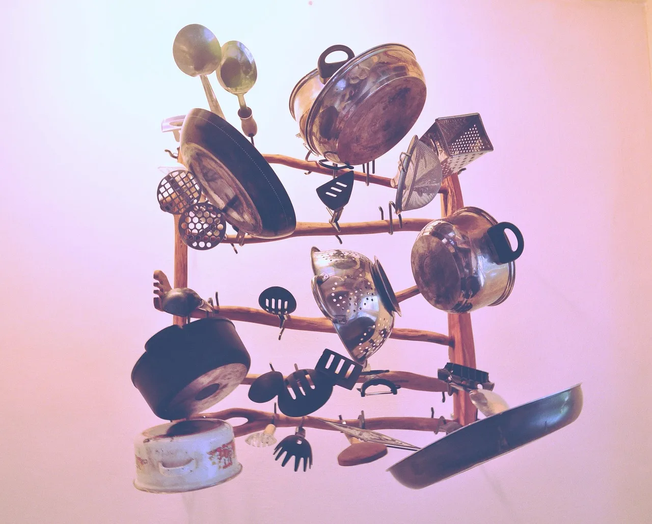 Cookware care kits beside cast iron, stainless steel, and nonstick pans on a kitchen counter