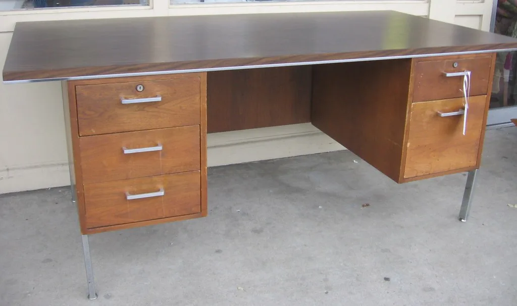 Close-up of a hand lifting a removable cabinet shelf liner from a kitchen shelf.
