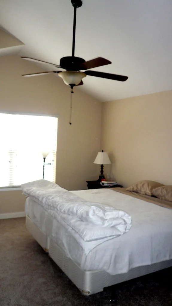 Tape measure and ceiling fan mounting hardware used to check bedroom ceiling height