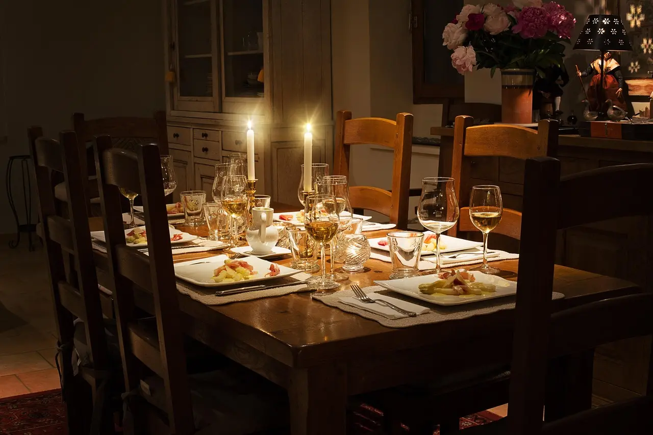 Small apartment dining nook with compact dining chairs beside a round table in natural light.