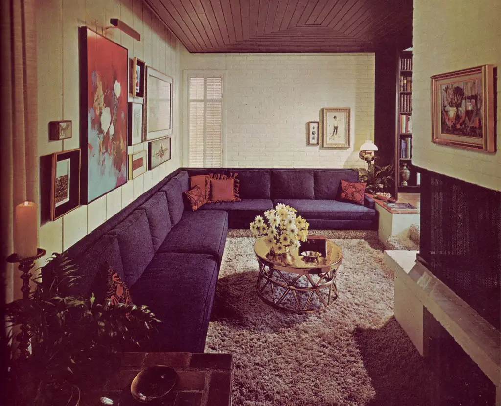 Compact sofa arm and measuring tape in a narrow hallway for delivery fit planning