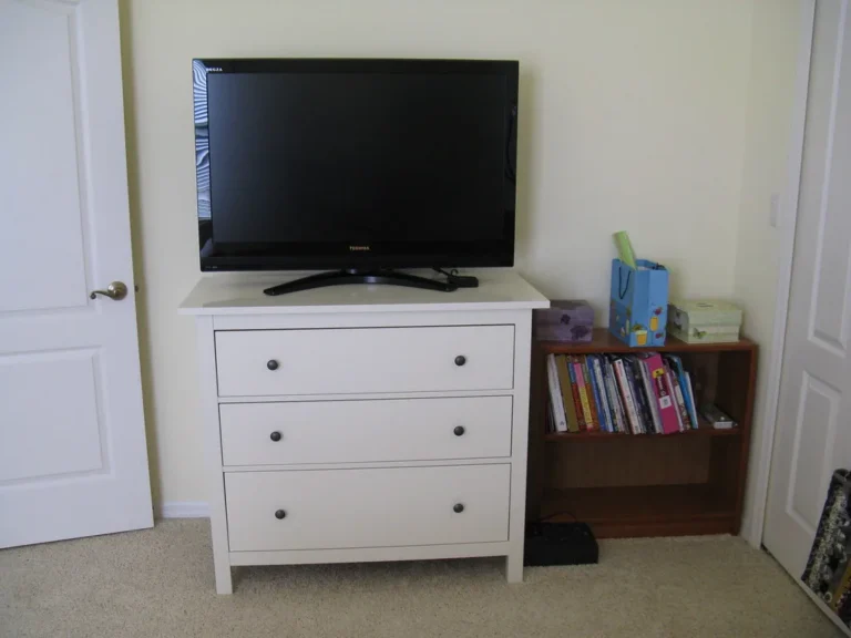 A storage-focused TV stand with baskets, cabinets, and shelves in a bright living room