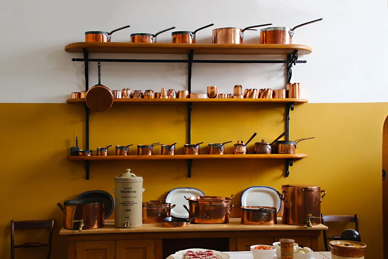 Home cook compares stainless steel, cast iron, ceramic-coated, and enameled cookware on a kitchen counter.