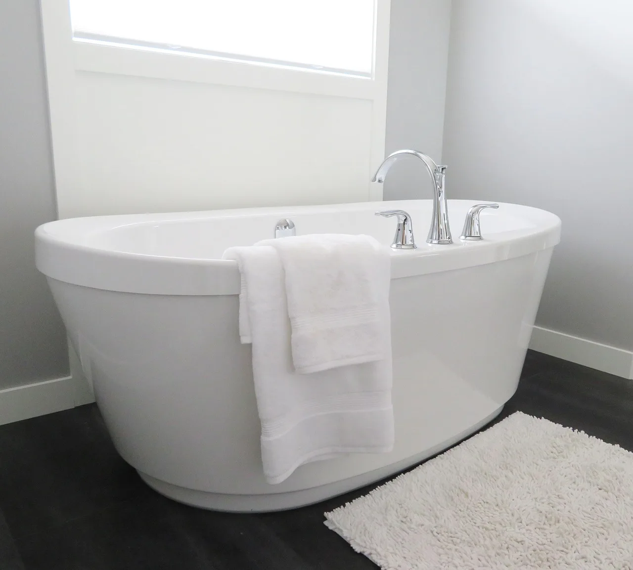 Moen Adler bathroom faucet on a white sink in a bright lived-in bathroom