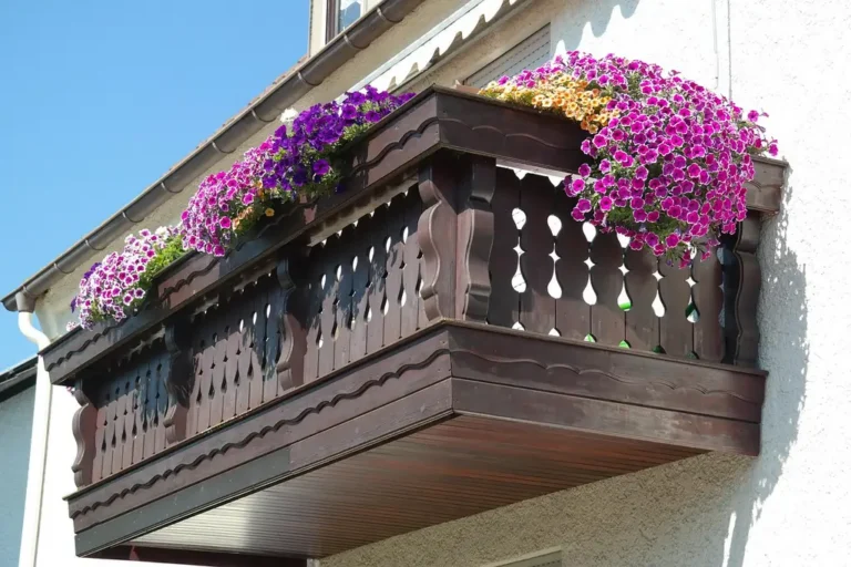 Balcony garden box and rail planter on a city balcony with plants and railing