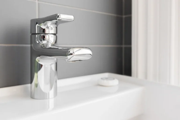 Bathroom faucet troubleshooting at a sink with a homeowner checking the handle and spout