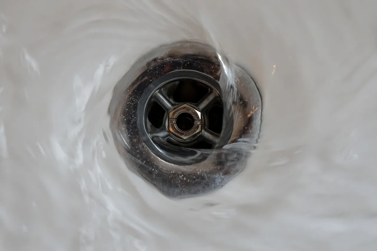 What causes a bathroom sink to drain slowly?