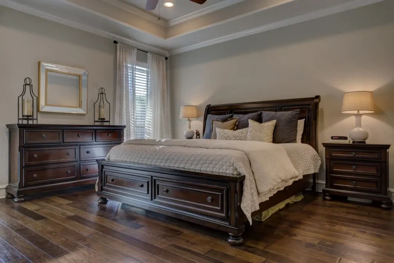 Bedroom with two windows dressed in layered curtains and soft natural light