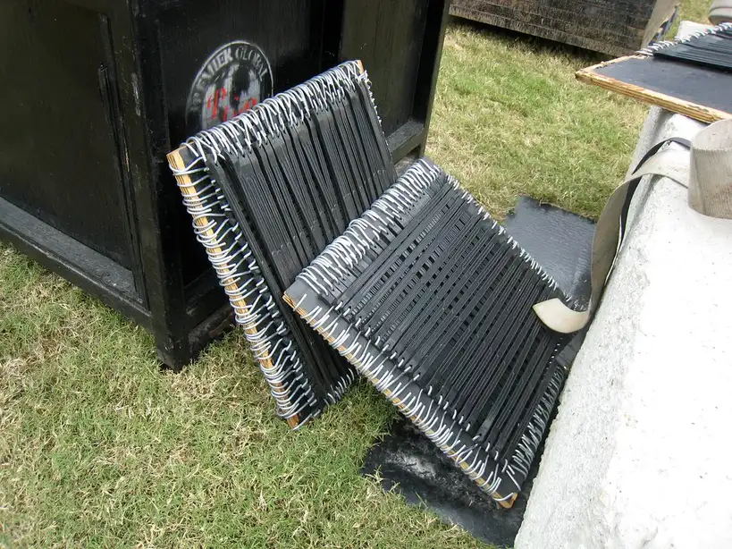 Hands fastening a bungee cord around a storage box on a shelf