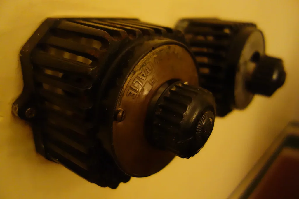 Close-up of a ceiling fan pull chain and nearby wall switch in a home interior.