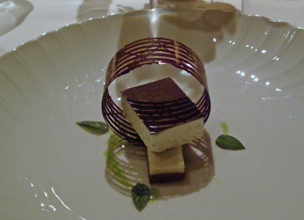 Melted chocolate being piped into heart molds on a countertop