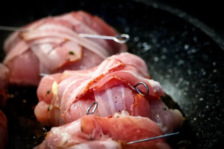 A grill pan searing vegetables on an electric stovetop in a bright apartment kitchen.