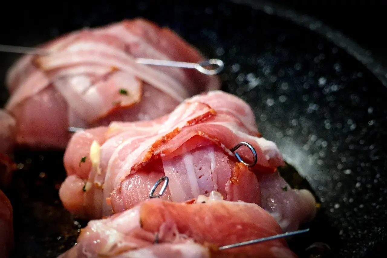 A grill pan searing vegetables on an electric stovetop in a bright apartment kitchen.