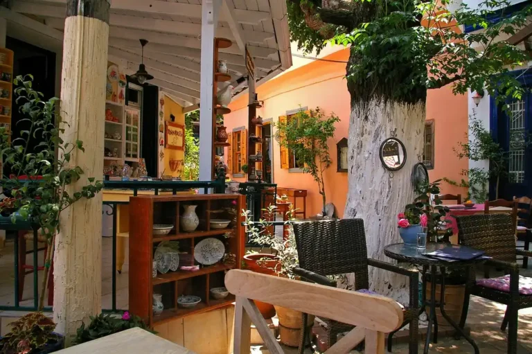Outdoor furniture in teak, aluminum, and wicker on a sunny patio near the coast