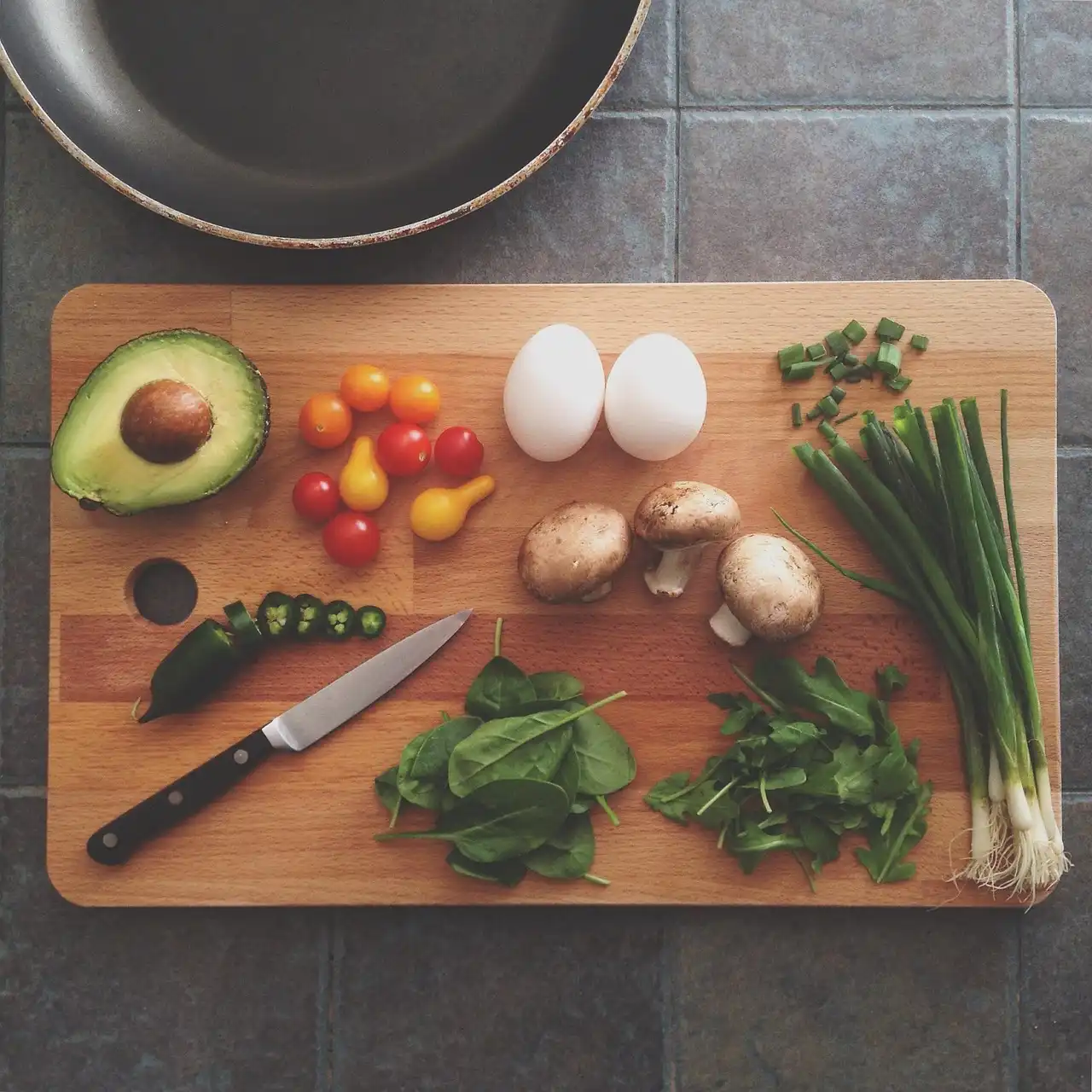 Family kitchen with a parent using a nonstick skillet and saucepan during dinner prep