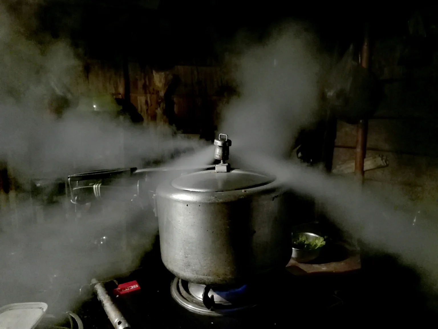 Close-up of a pressure cooker lid being locked before cooking