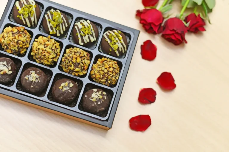Two small Valentine’s Day desserts for two on a bright kitchen counter with forks and roses