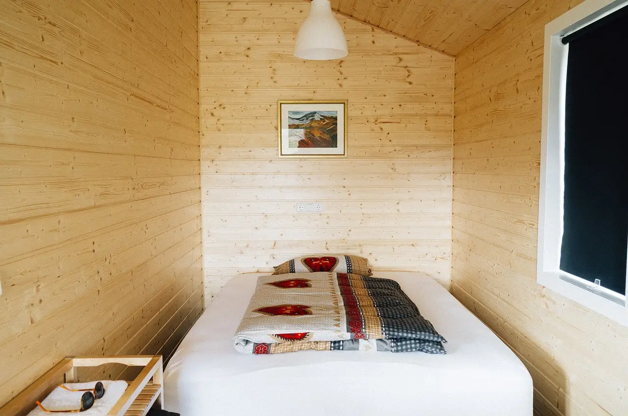 Boho bedroom and farmhouse bedroom split in one room with layered textiles, shiplap, and neutral decor