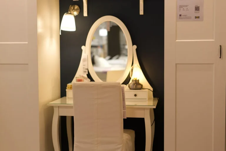 Bedroom scene with a dresser mirror and a wall mirror beside a wooden dresser in natural light