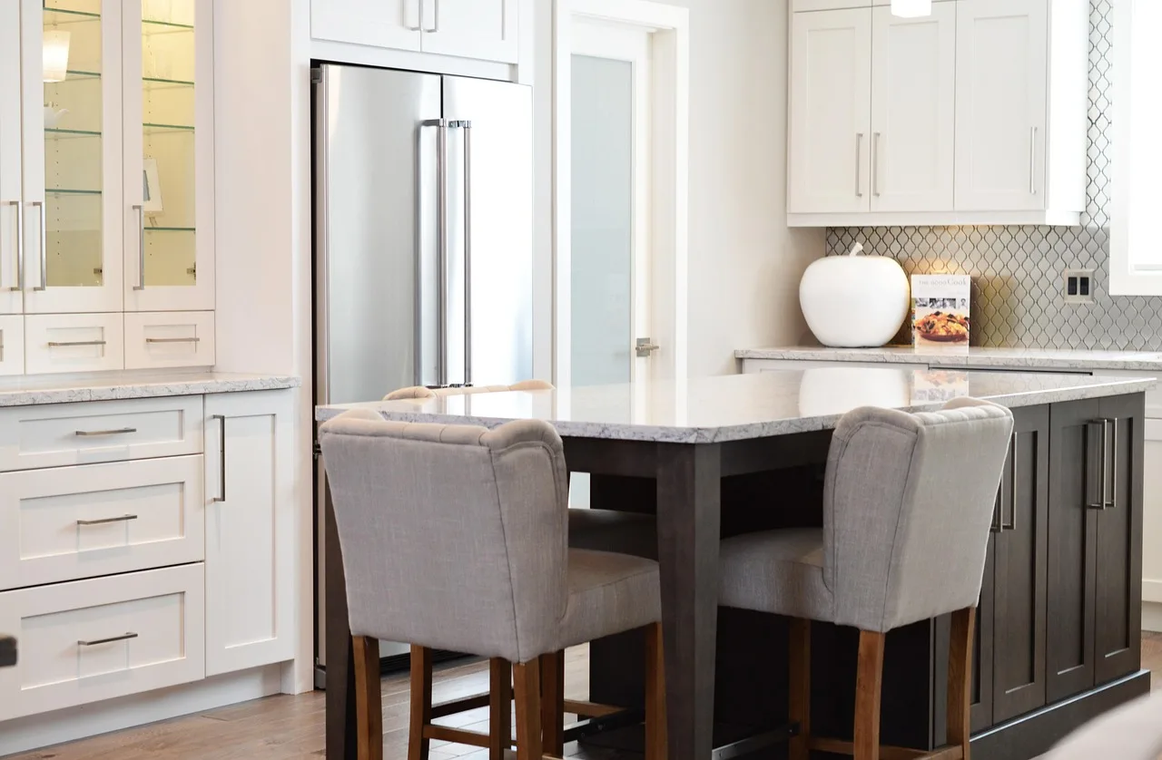Kitchen showing full overlay cabinets beside partial overlay cabinets in natural light