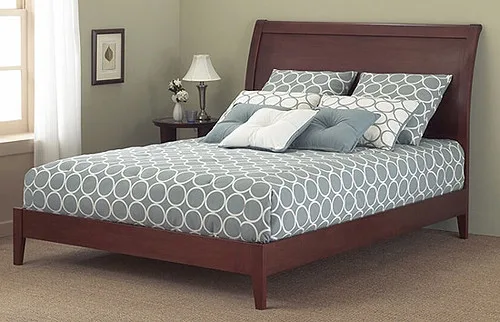 A hand presses a sofa bed mattress seam to reveal sagging foam and wear.