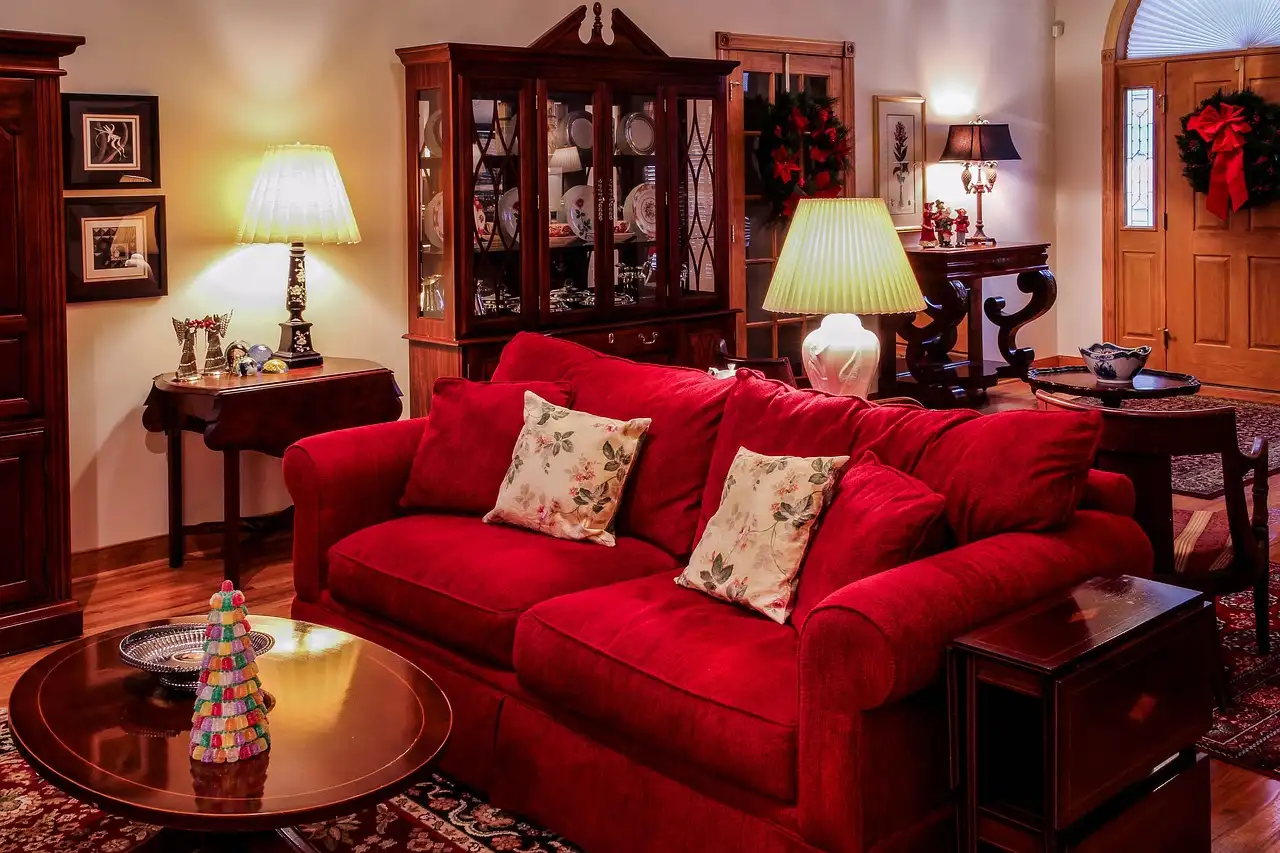 Decorated coffee table with tray, candles, books, and greenery in a Christmas living room