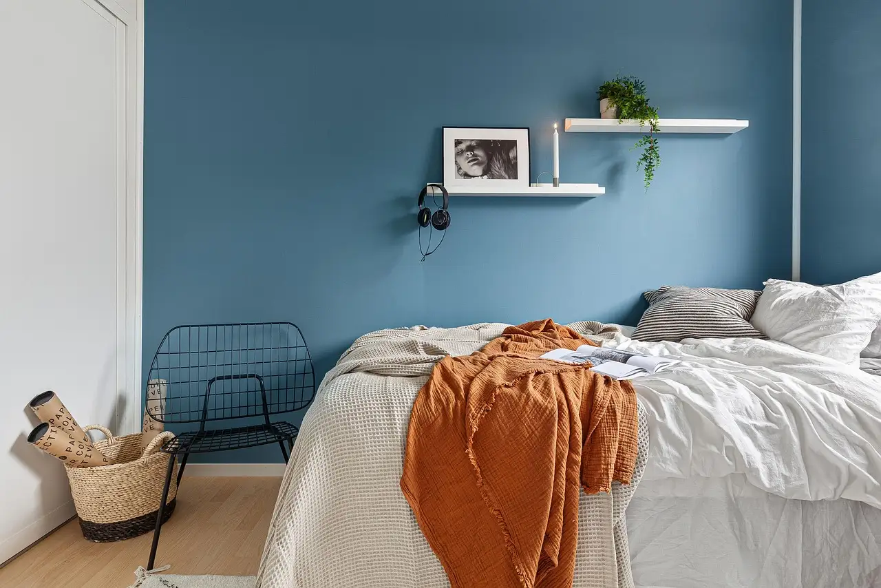 Handyman inspecting a wobbly wooden bed frame corner joint in a bedroom