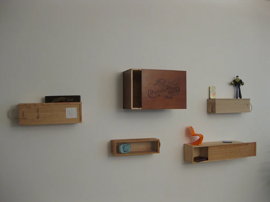 Close-up of a KALLAX shelf cube with books, a record crate, and a woven bin