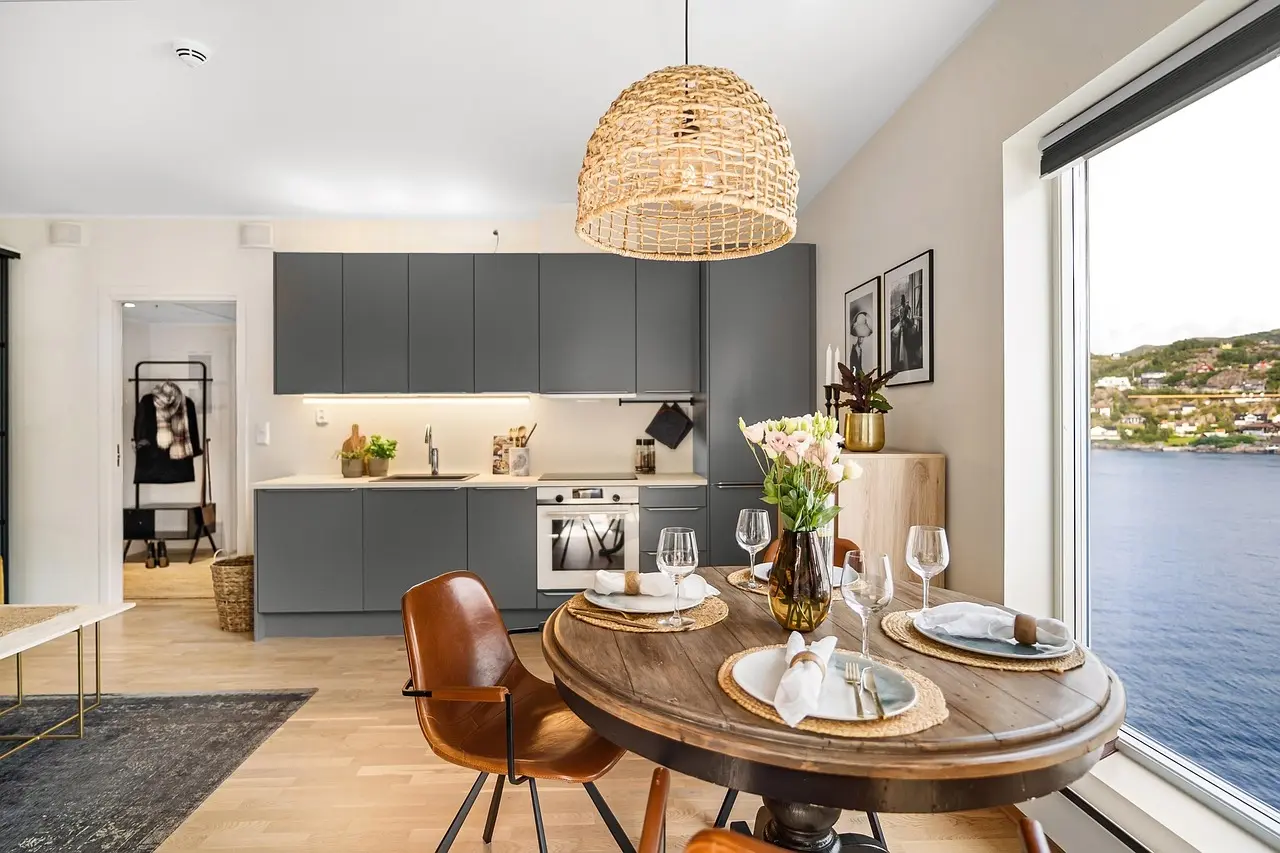 Homeowner reviewing freshly painted kitchen cabinet doors and paint samples in a bright kitchen