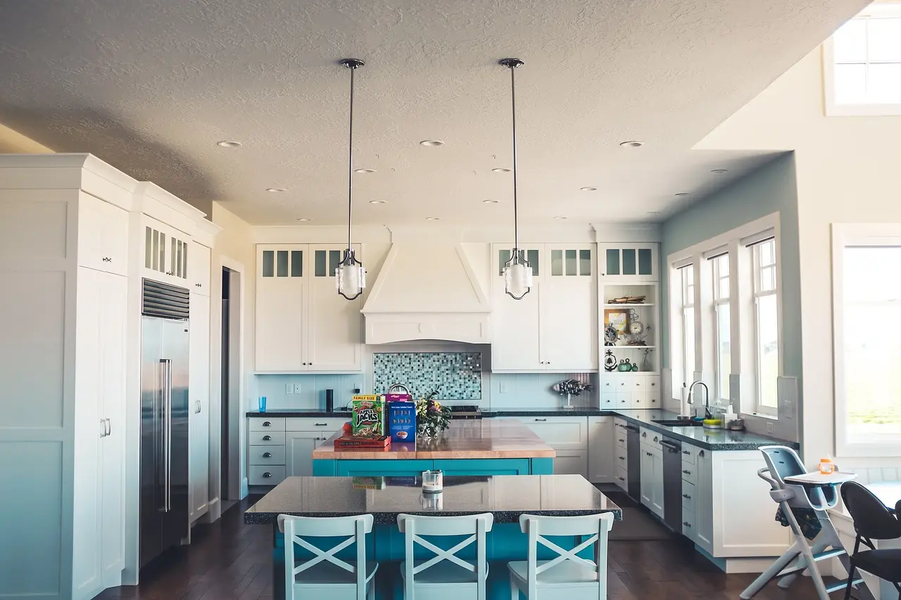 Homeowner and designer reviewing KraftMaid cabinet samples in a bright kitchen renovation