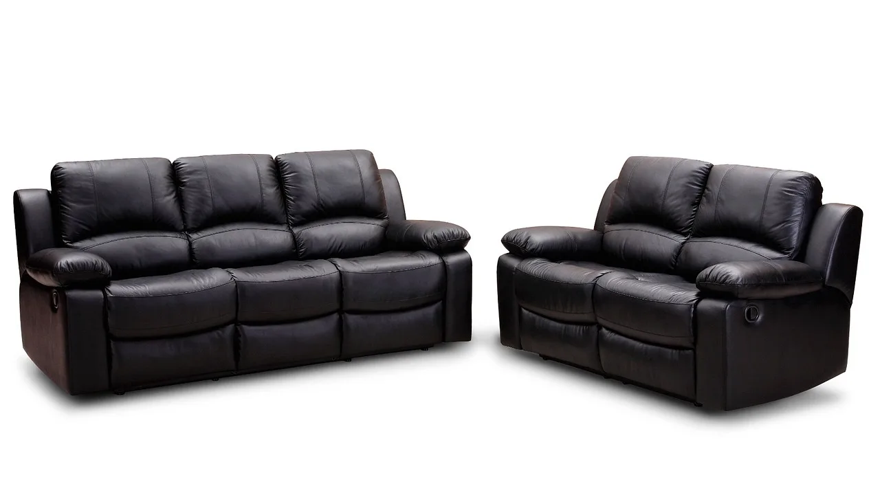 Leather sofa cleaner kits on a coffee table beside a tan leather sofa in natural light