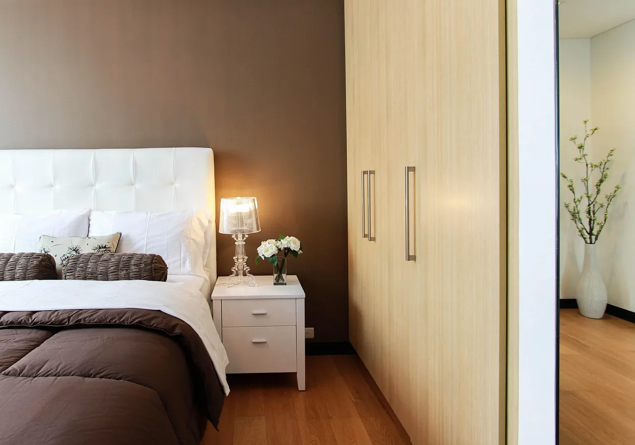 Prepac dresser in a natural-light bedroom, placed against a wall with a visible safety anchor