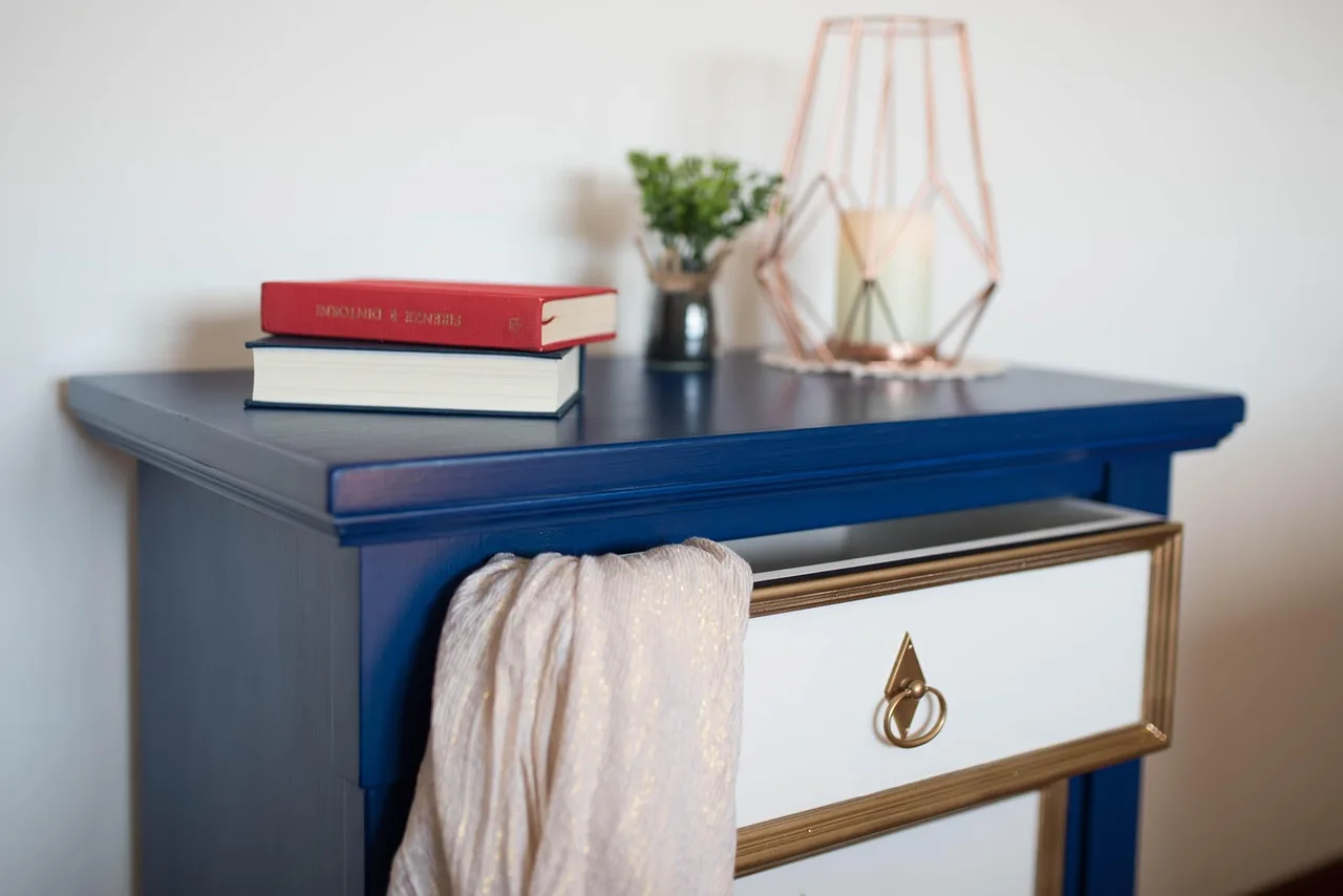 RTA dresser beside flat-pack boxes in a sunlit bedroom, with hardware and instructions visible