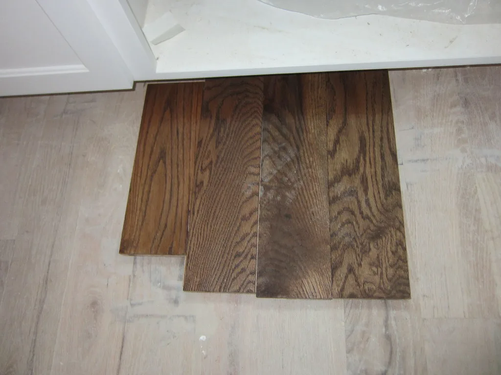 Close-up of Shaker and raised panel cabinet door profiles being wiped clean.