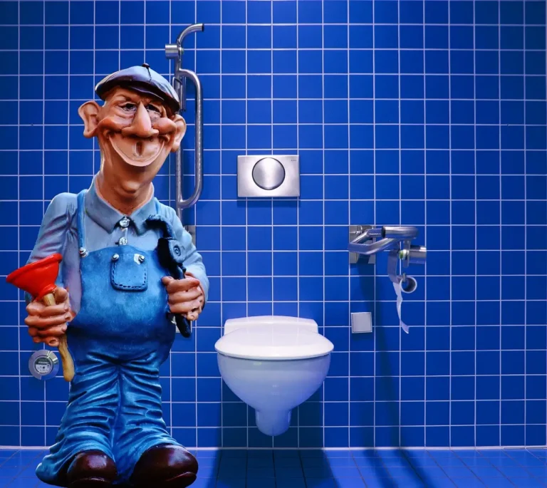 Plumber replacing a toilet in a small bathroom with tools and a new toilet box nearby