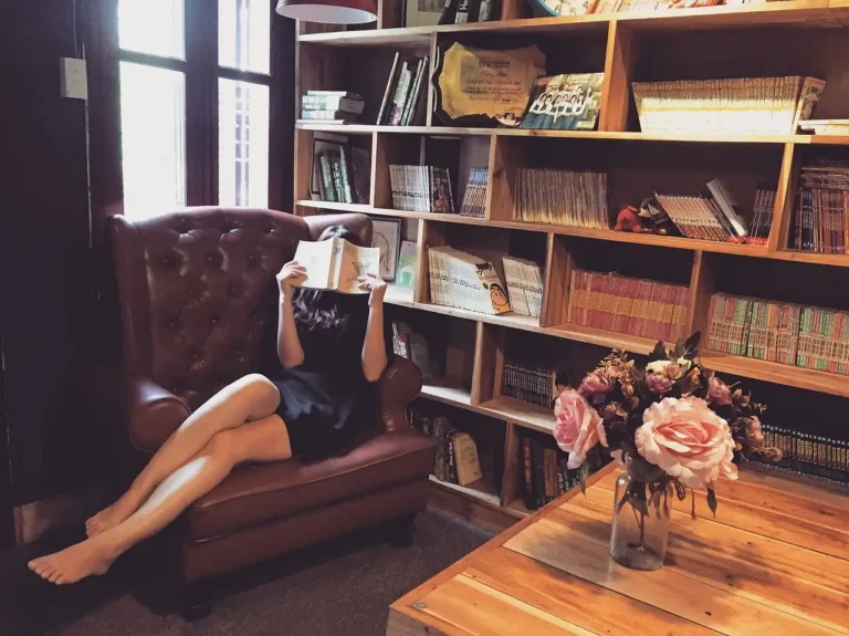 West Elm bookshelf in a bright living room styled with books, ceramics, and a basket