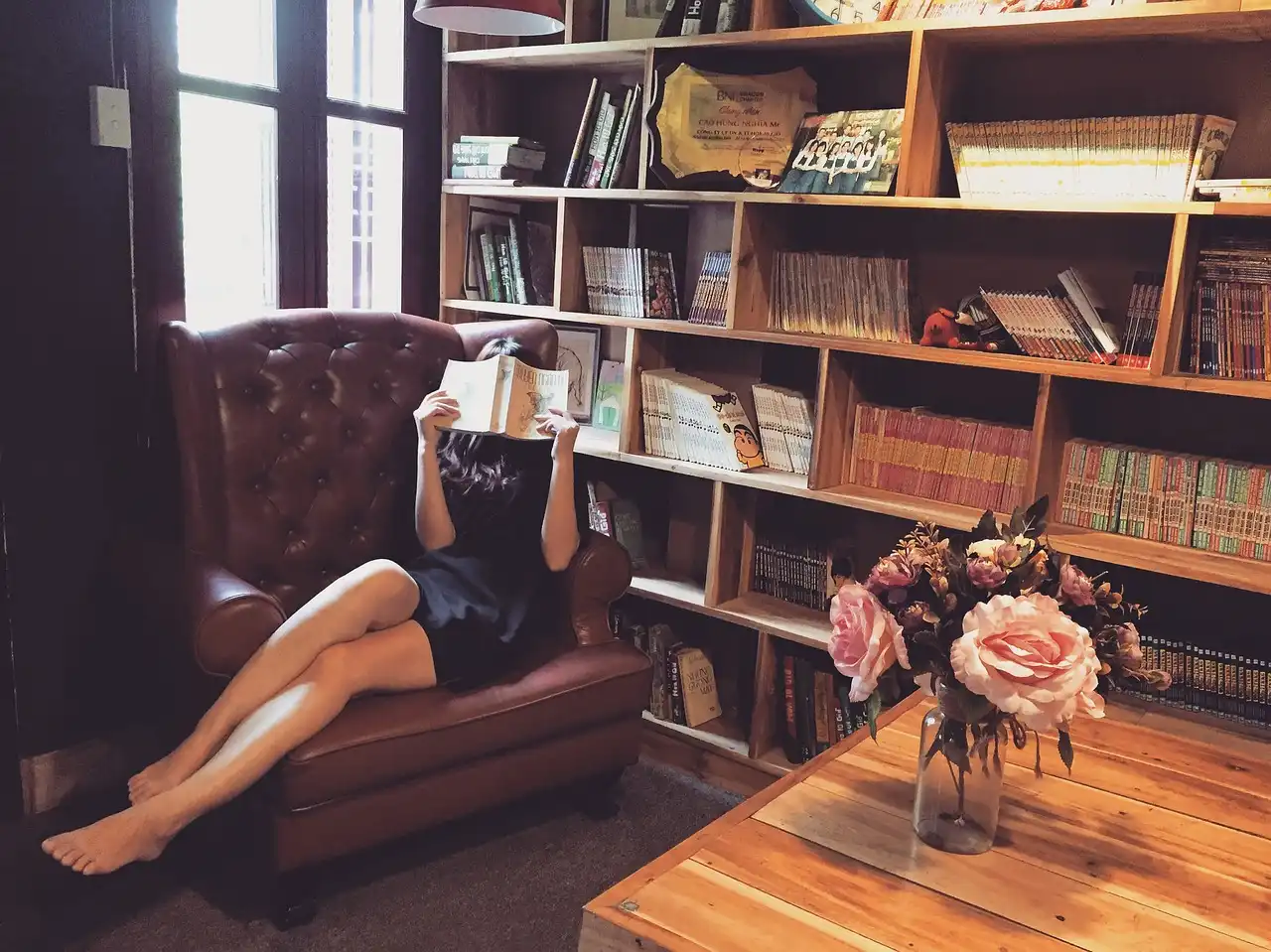 West Elm bookshelf in a bright living room styled with books, ceramics, and a basket