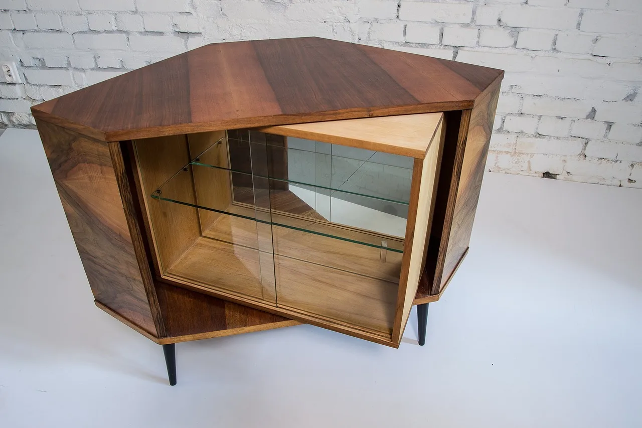 Wood dresser and laminate dresser side by side in a bright bedroom, showing wear differences
