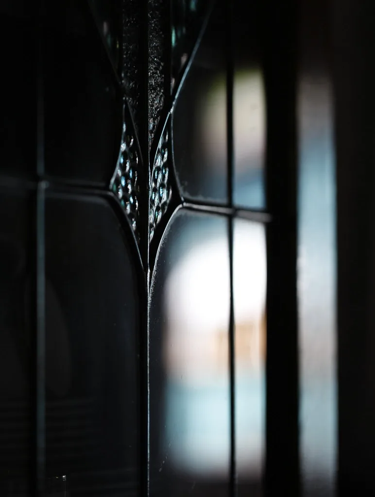Close-up of a laminate dresser chip beside a wood drawer edge under natural light